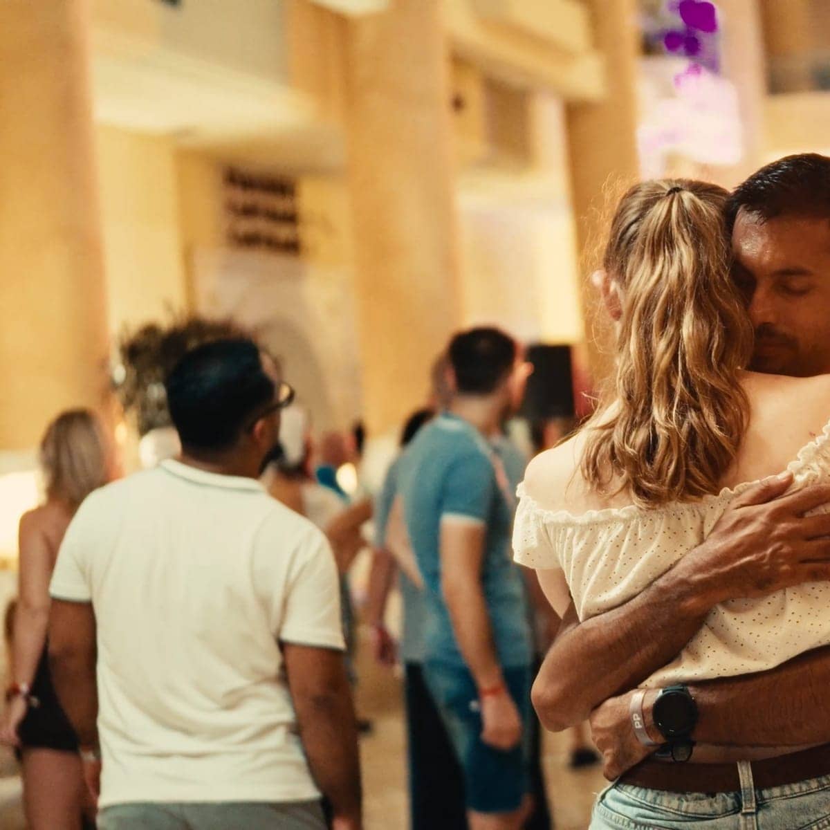 A couple in close embrace at the evening pool party