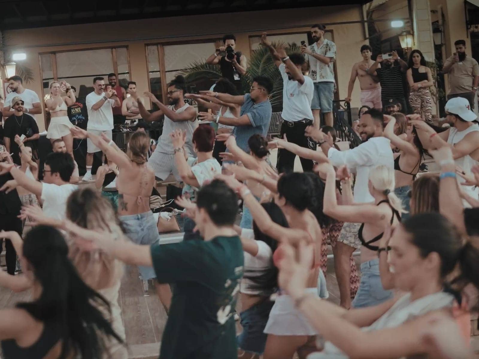 Dancers filling the courtyard at a daytime social